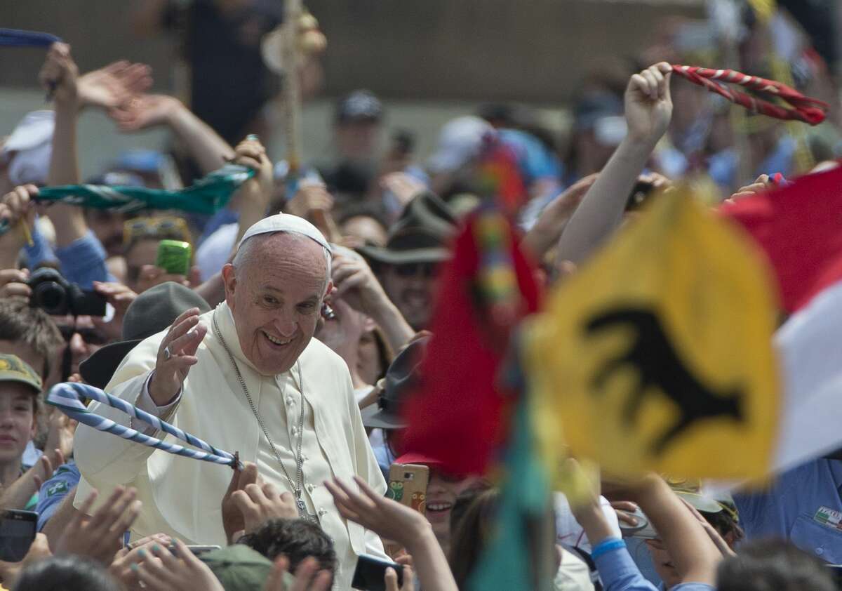 Pope Francis is cheered by the crowd as he arrives for an audience with Italian AGESCI boy scouts association’s members in St. Peter’s Square at the Vatican on June 13, 2015.