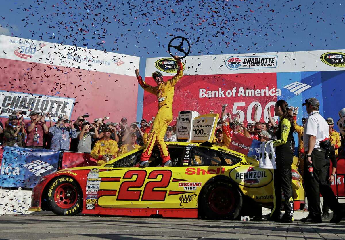 Joey Logano celebrates in Victory Lane after winning at Charlotte Motor Speedway on Sunday.