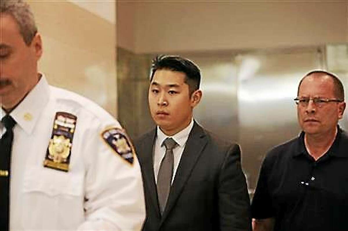 New York City Police Officer Peter Liang leaves court after his arraignment.