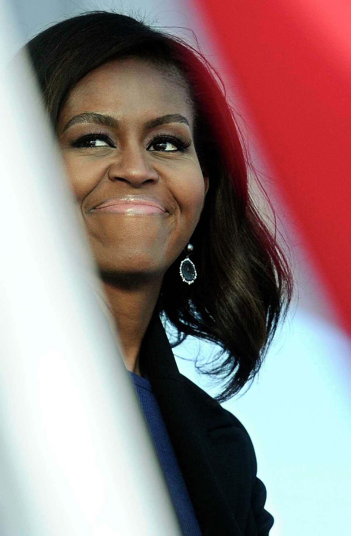 First lady Michelle Obama smiles during christening ceremonies at Electric Boat, a division of General Dynamics, shipyard on Oct. 10, 2015 in Groton, Conn. The $2.7 billion vessel is the 13th in the Virginia class of submarines, which can carry out a range of missions including anti-submarine warfare, delivery of special forces, and surveillance.