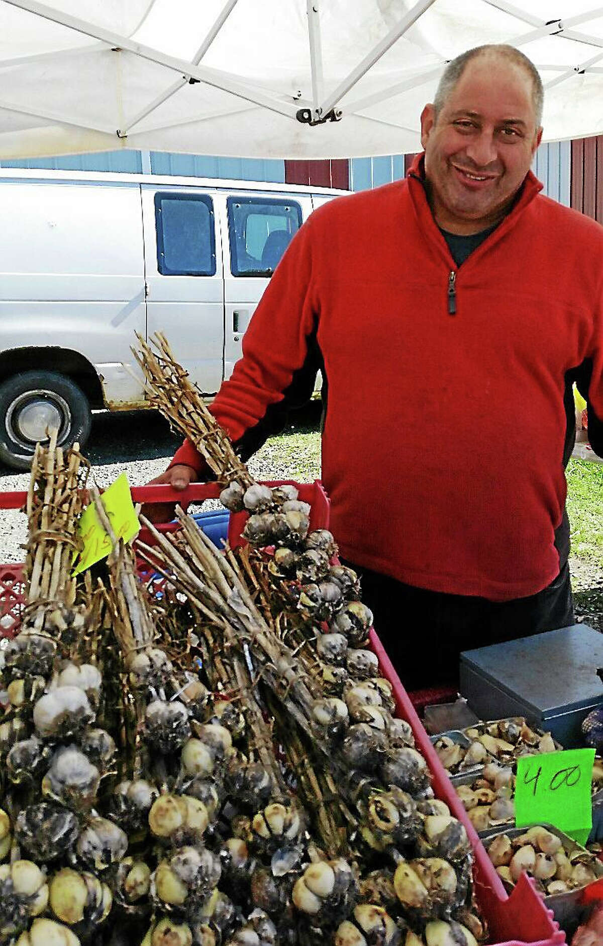 N.A. Ambery photo Anthony Caltabiano of Caltabiano Farms in Phoenix, New York, sells German white garlic bulbs at the 11th Annual Connecticut Garlic & Harvest Festival.