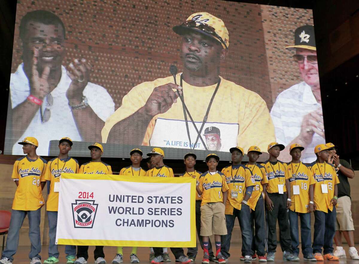 In this Aug. 27, 2014 file photo, members of the Jackie Robinson West All-Stars Little League team participate in a rally celebrating their U.S. championship in Chicago.