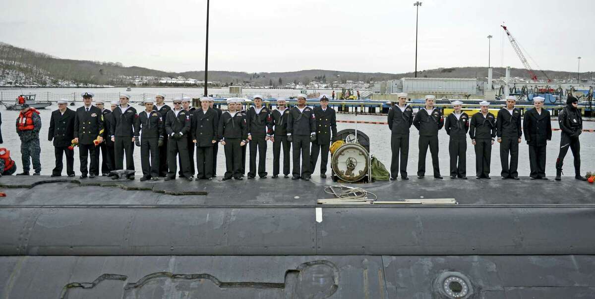 The crew of the U.S. Navy attack submarine USS Missouri (SSN 780) gather on the deck awaiting clearance to go ashore and reunite with their families as the sub returns to the Navy Submarine Bast in Groton, Conn., Friday, Feb. 12, 2016 following a six-month deployment to the European Command area of responsibility. The Missouri, the seventh sub in the Virginia-class, made port calls in Faslane, Scotland, Rota, Spain and Brest, France during the deployment.