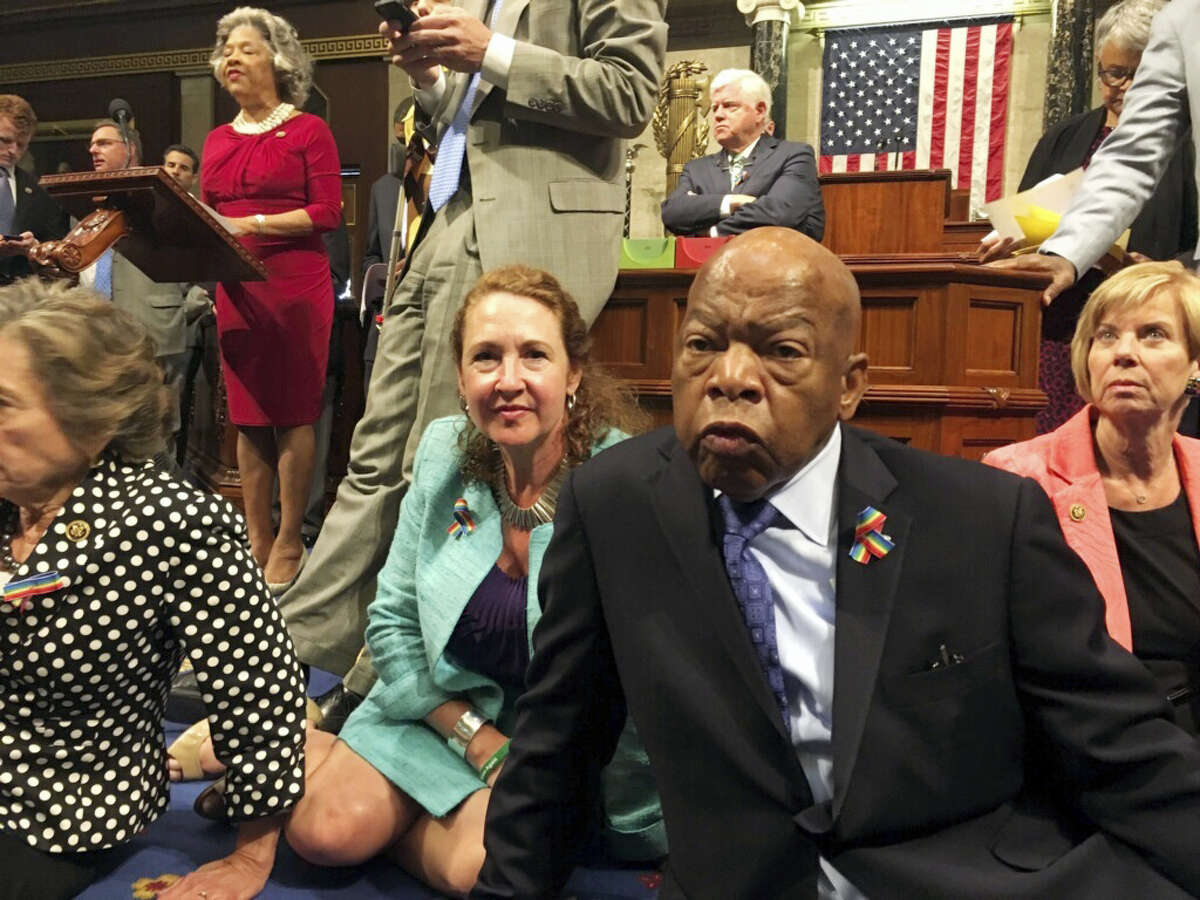 This photo provided by U.S. Rep. Chillie Pingree,D-Maine, shows Democrat members of Congress, including Rep. John Lewis, D-Ga., center, and Rep. Elizabeth Esty, D-Conn. as they participate in sit-down protest seeking a vote on gun control measures Wednesday on the floor of the House on Capitol Hill in Washington.