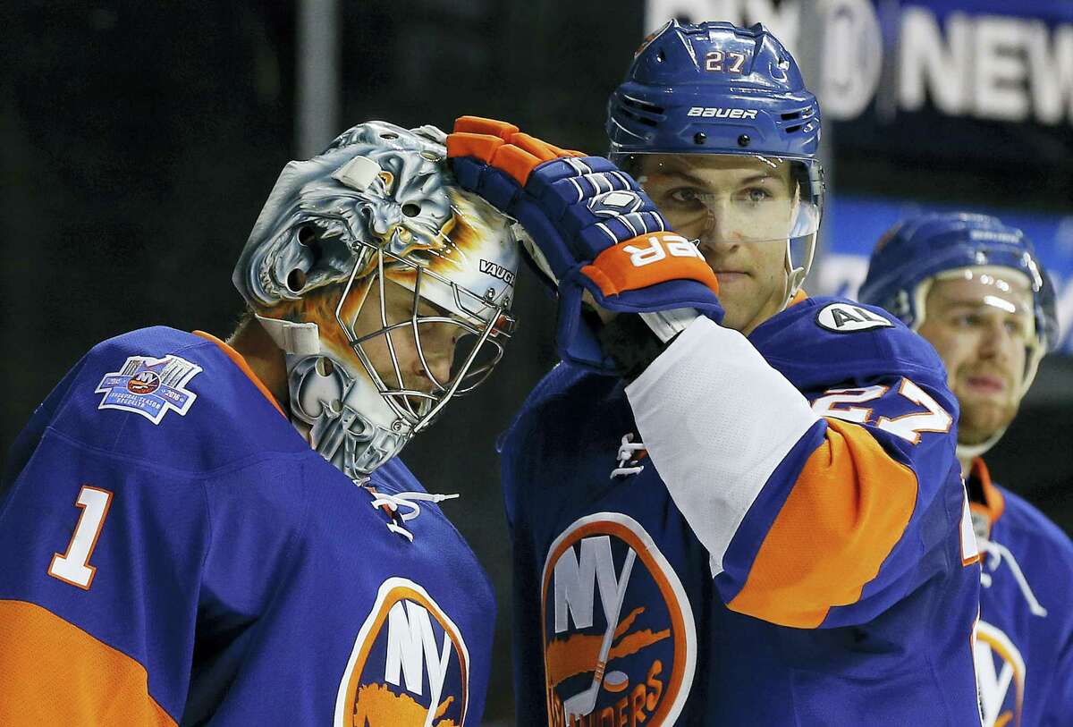 New York Islanders center Anders Lee (27) greets goalie Thomas Greiss (1) after the Islanders defeated the Los Angeles Kings 5-2 Thursday.
