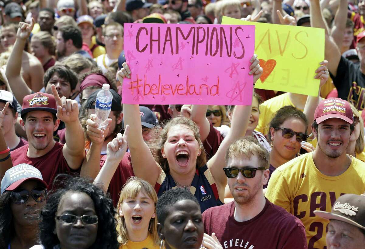 Cavaliers fans cheer as they wait for the team’s arrival in Clevleand on Monday.