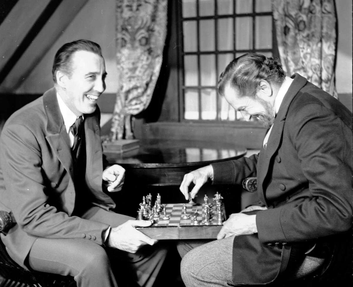 FILE - In this file photo dated Dec. 17,1968, British actor Christopher Lee, left and American actor Vincent Price, share a joke whilst playing chess during a break in the filming of Edgar Allen Poe's "The Oblong Box", at Shepperton Studios, England. Lee, the prolific, aristocratic British actor who brought dramatic gravitas to the low-budget thrills of Hammer Studios' 1950s and 1960s horror films and to the more recent "The Lord of the Rings" trilogy and two of George Lucas' "Star Wars" prequels, has died at age 93, the Royal Borough of Kensington and Chelsea in London confirmed a death certificate was issued for Lee on June 8. (AP Photo/Bob Dear, FILE)