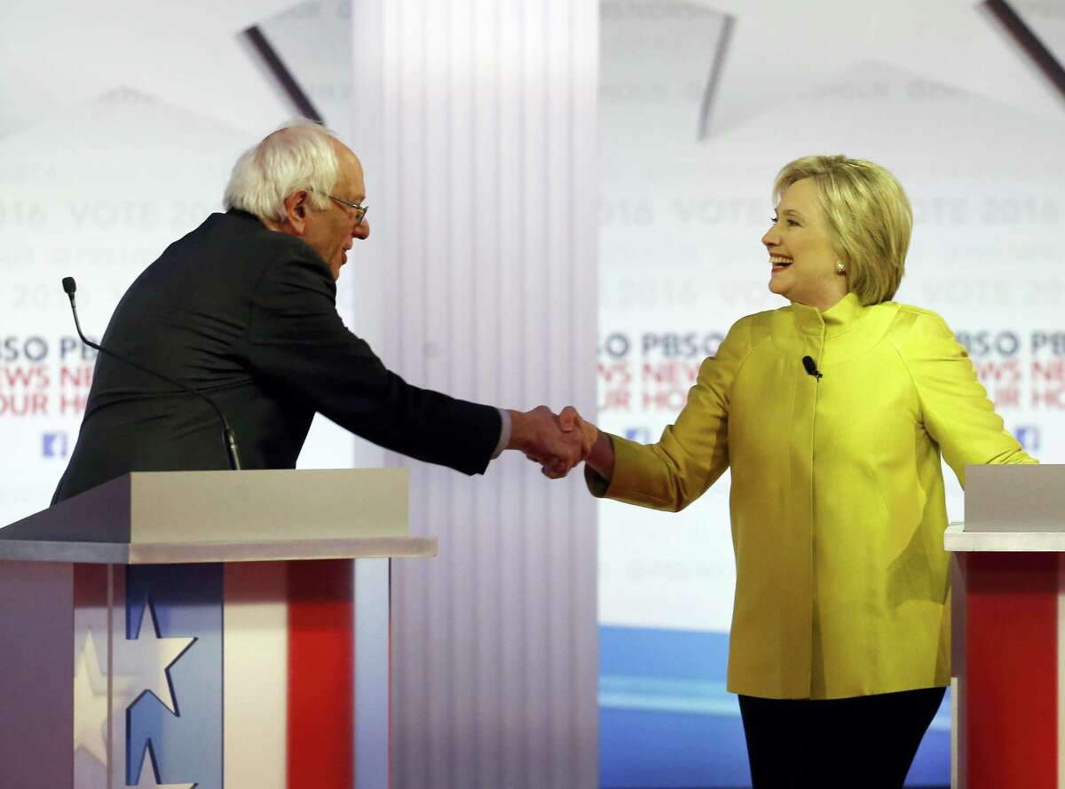 Democratic presidential candidates Sen. Bernie Sanders, I-Vt., and Hillary Clinton shake hands after a Democratic presidential primary debate at the University of Wisconsin-Milwaukee Thursday.