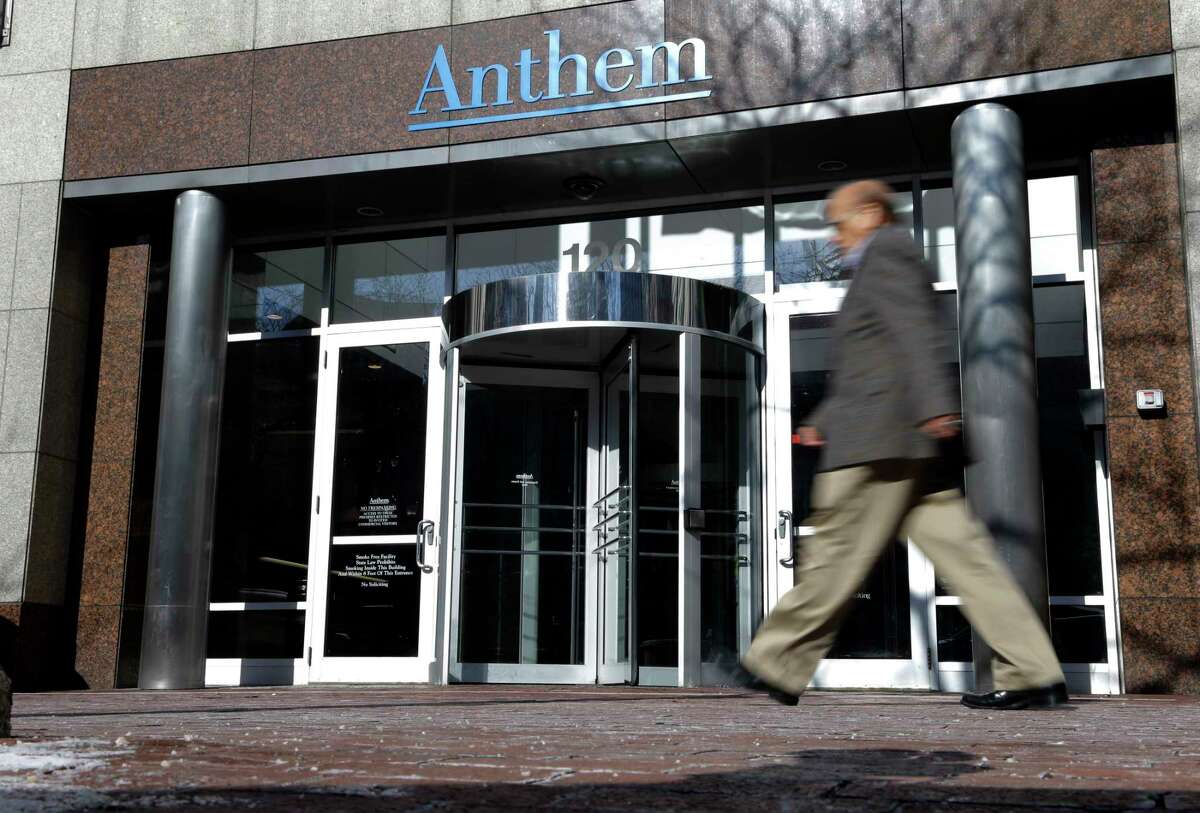 A man walks past health insurer Anthem’s corporate headquarters in Indianapolis.