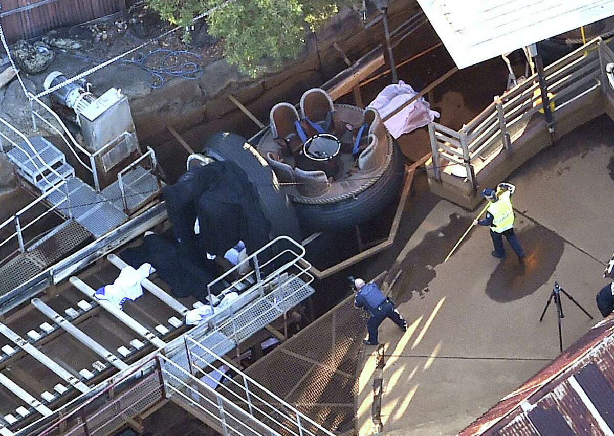 Queensland Emergency Services personnel are seen at the Thunder River Rapids ride at Dreamworld on the Gold Coast, Australia, Tuesday, Oct. 25, 2016. Four people died after a malfunction caused two people to be ejected from their raft, while two others were caught inside the ride at the popular theme park.