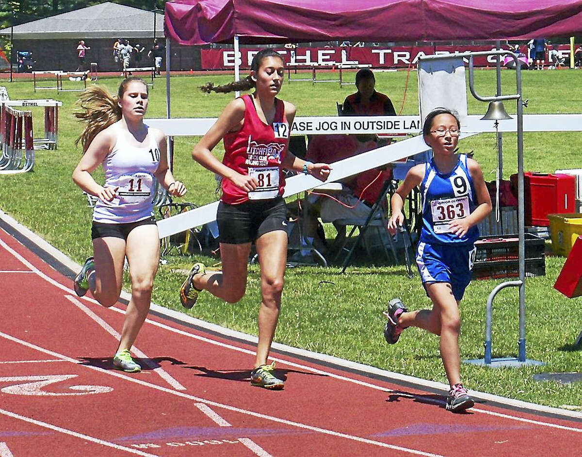 Submitted PhotoTorrington's Gabrielle Vega (center) won the girls 17-18 division 3,000 meters and 1,500 meters at Connecticut's Junior Olympics Championships at Bethel High School Sunday.