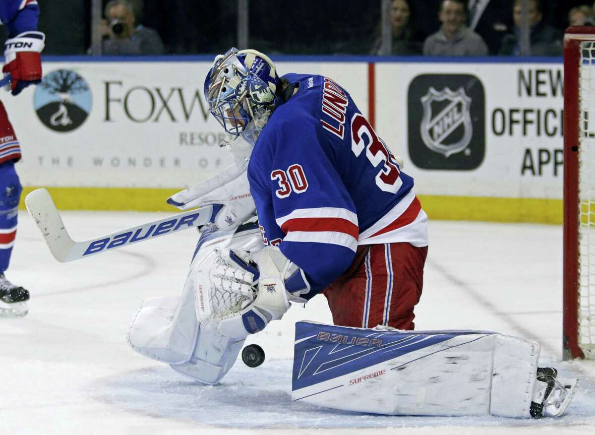 New York Rangers goalie Henrik Lundqvist (30) makes a save against the New Jersey Devils in the third period of an NHL hockey game Monday, Feb. 8, 2016, in New York. The Rangers defeated the Devils 2-1. (AP Photo/Adam Hunger)