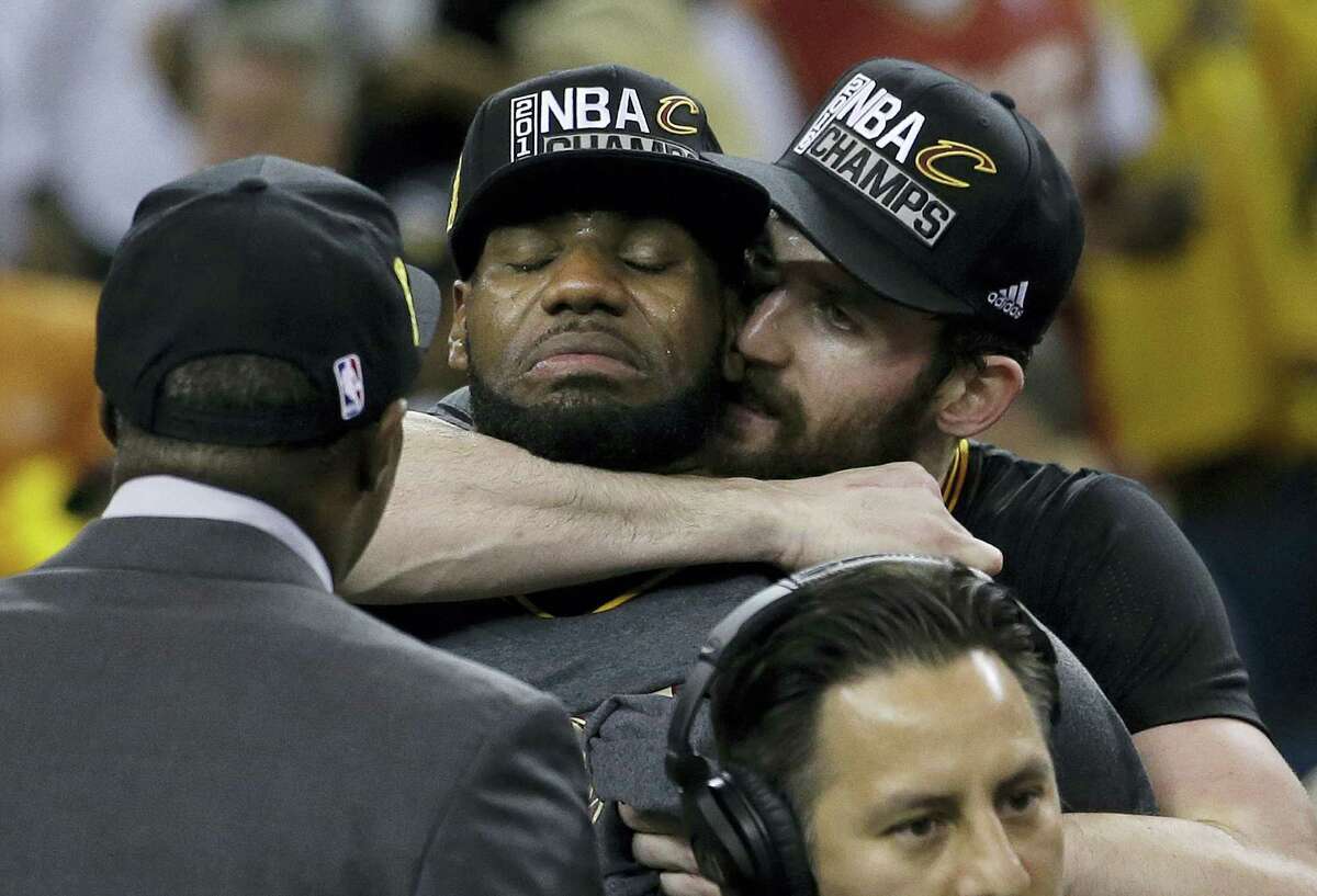 LeBron James, left, is hugged by Kevin Love after Game 7.