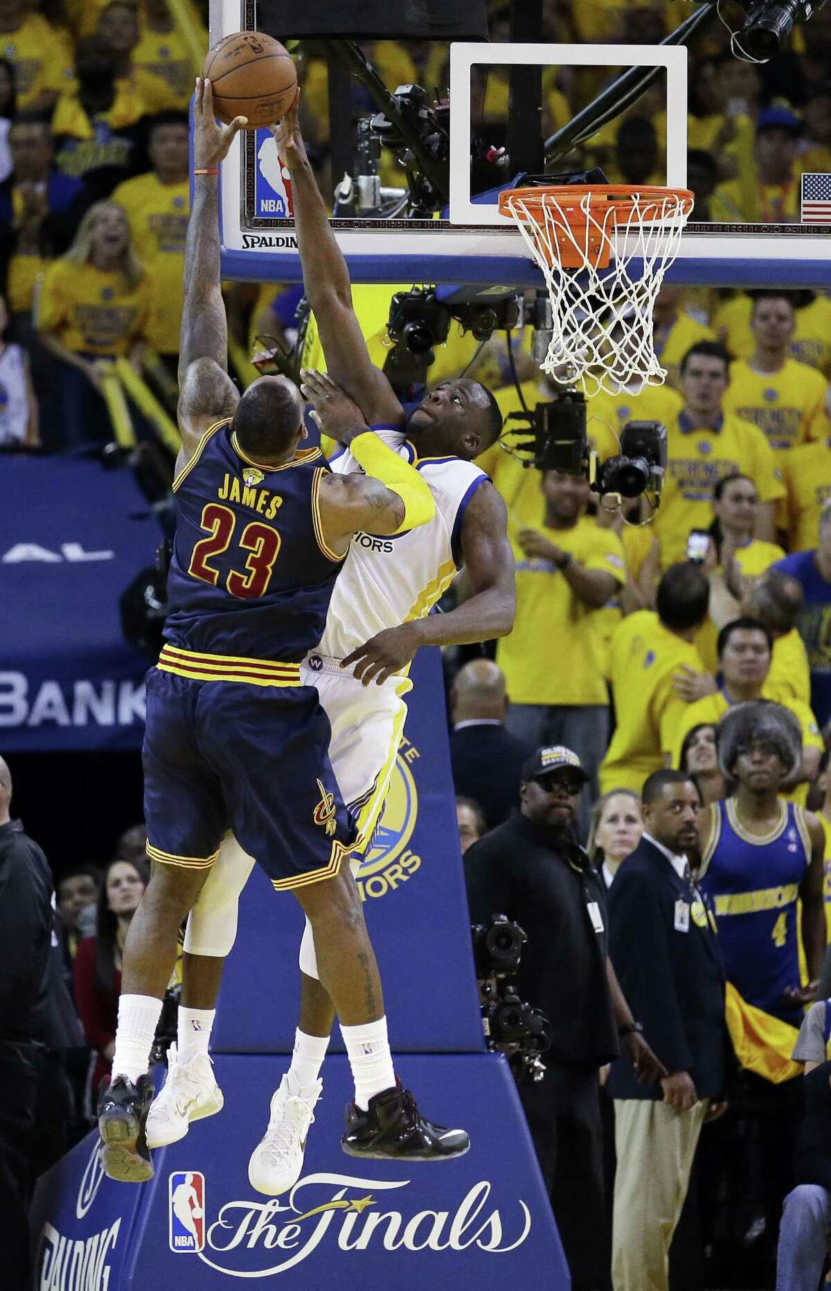 Golden State Warriors forward Draymond Green, right, blocks a shot attempt by Cleveland Cavaliers forward LeBron James during the overtime period of Game 2 of basketball’s NBA Finals in Oakland, Calif. on June 7, 2015. The Cavaliers won 95-93 in overtime.