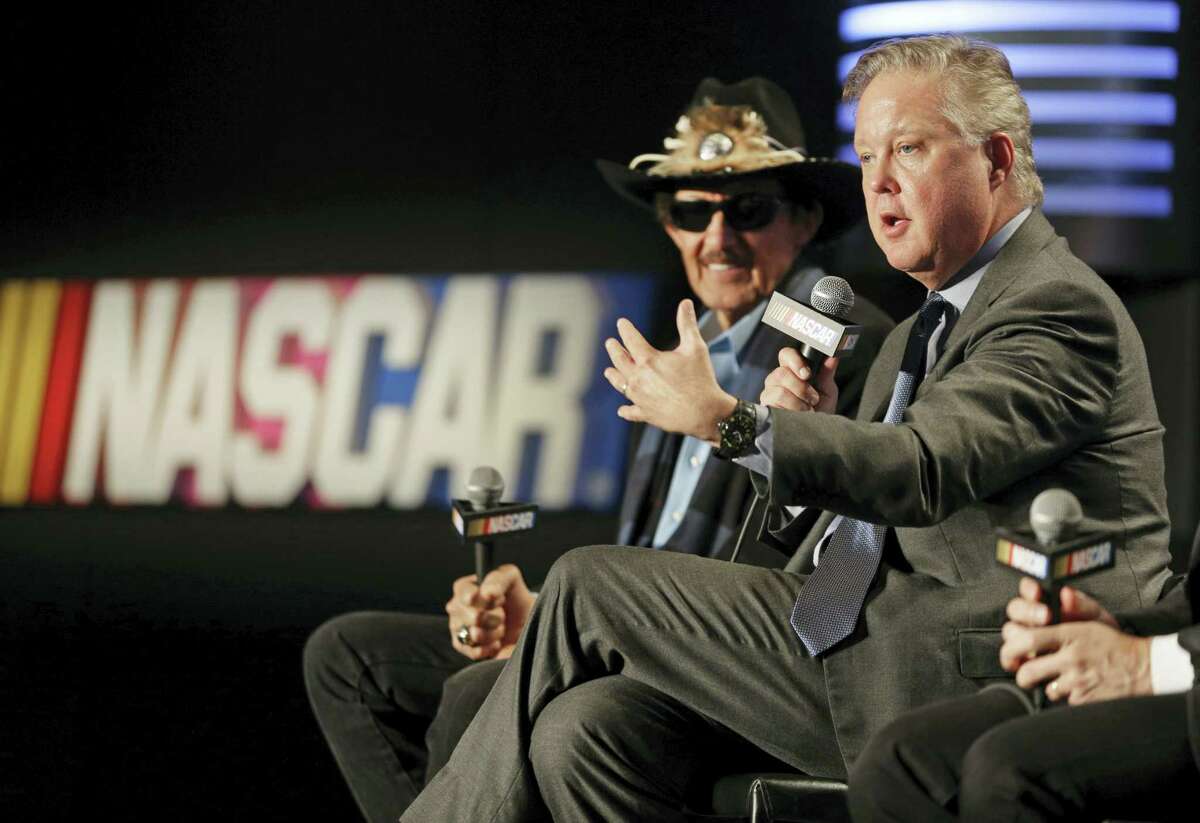 NASCAR Chairman and CEO Brian France, right, speaks as team owner Richard Petty, left, listens during a news conference in Charlotte, N.C., on Tuesday.