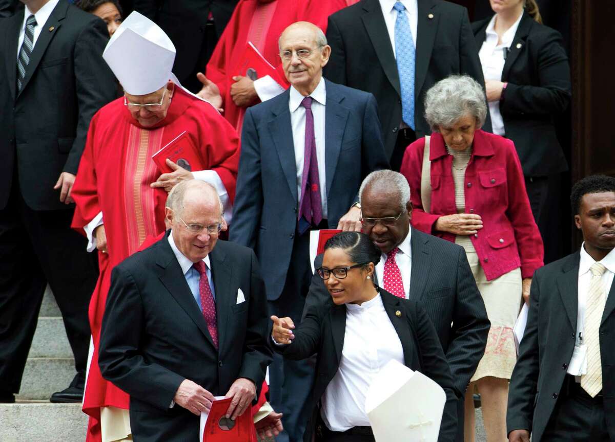 U.S. Supreme Court Justices Anthony M. Kennedy, left, Stephen Breyer, center, and Clarence Thomas, leave St. Mathews Cathedral, after the Red Mass in Washington on Oct. 4, 2015. The Supreme Court’s new term starts Monday, Oct. 5.