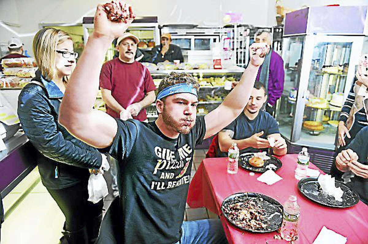 Arnold Gold — New Haven Register Brandon “Feast Mode” Carr rejoices after winning the annual paczki-eating contest at Eddy’s Bake Shop in Ansonia.