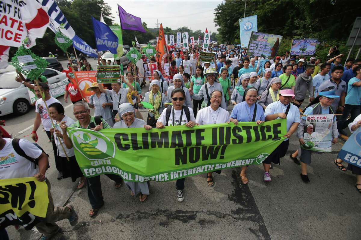 Filipino nuns and priests, along with Catholic groups, lead a march to raise awareness on the dangers of climate change in suburban Quezon city, north of Manila, Philippines.