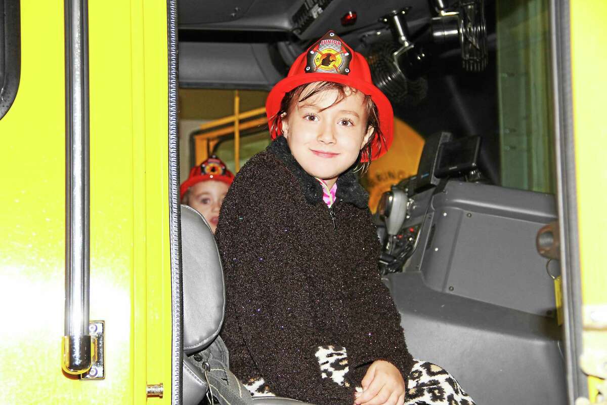 Bobby Laboy, 6, of Torrington, gets to sit in a fire engine Monday evening during an open house of the Torringford Volunteer Fire Department.
