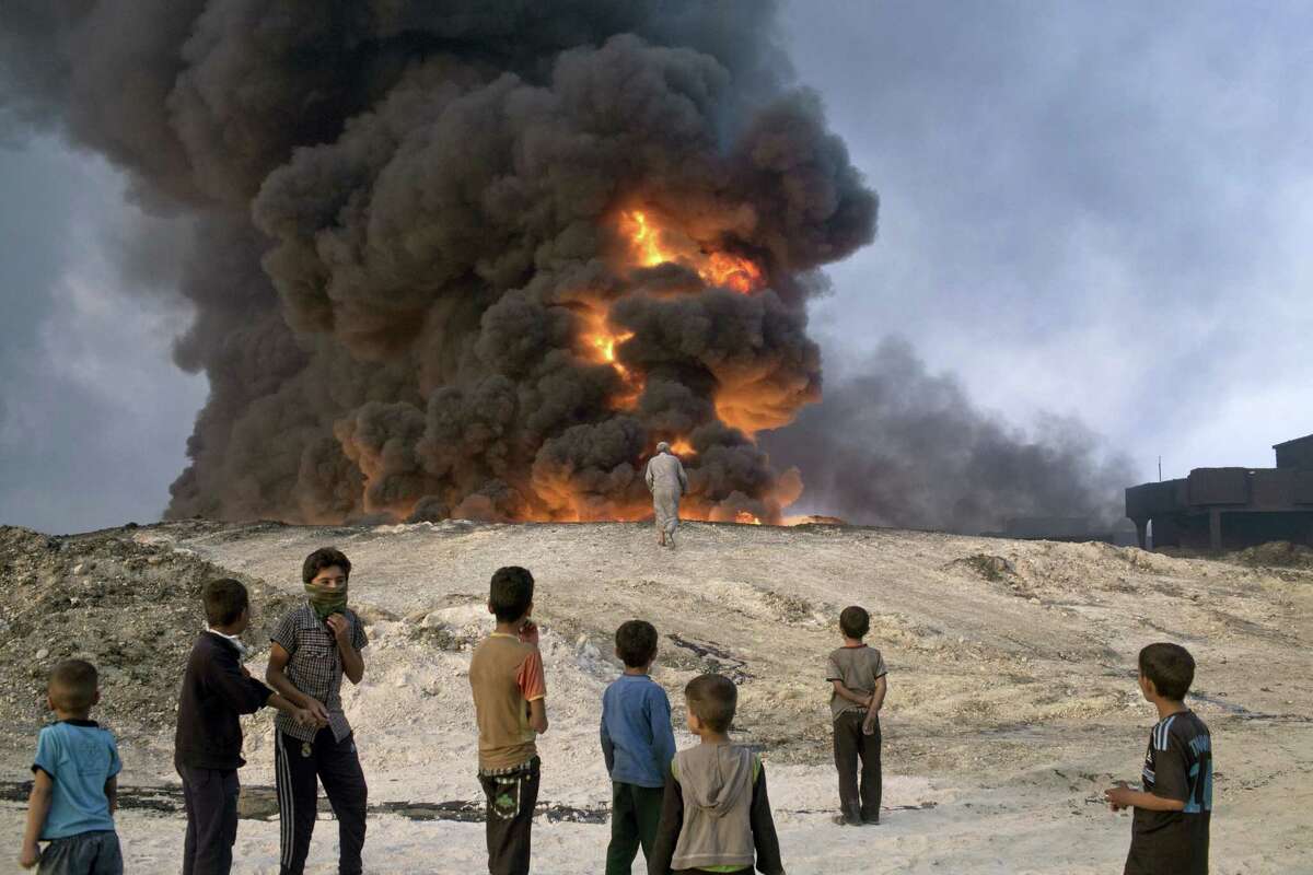 In Qayyarah, some 50 kilometers south of Mosul, Iraq on Oct. 23, 2016 Islamic State fighters torched a sulfur plant sending a cloud of toxic fumes into the air that mingled with oil wells the militants had lit on fire to create a smoke screen.