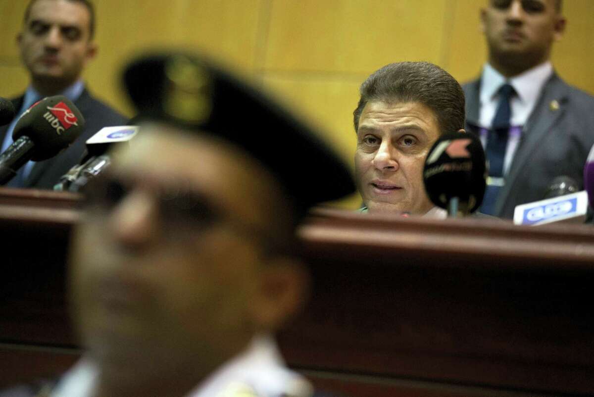 Egyptian judge, Mohammed Shirin Fahmy, second right, reads the verdict against former Egyptian President Mohammed Morsi, in a makeshift courtroom at the national police academy, in an eastern suburb of Cairo, Egypt, Saturday, June 18, 2016. An Egyptian court has sentenced six people, including two Al-Jazeera employees, to death for allegedly passing documents related to national security to Qatar and the Doha-based TV network during the rule of Islamist president Mohammed Morsi. Morsi, the case’s top defendant, was also sentenced on Saturday to 25 years in prison. He was ousted by the military in July 2013, and has already been sentenced to death in other cases.