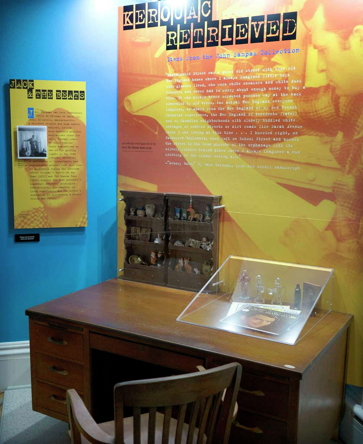 In this Sept. 18, 2015, photo provided by the University of Massachusetts, Lowell, some of author Jack Kerouac’s belongings, including a Frank Sinatra album and collection of figurines, are displayed on the desk where he once wrote, in the exhibit “Kerouac Retrieved: Items from the John Sampas Collection,” at the university in Lowell, Mass. The exhibit opens in Kerouac’s hometown on Oct. 8.