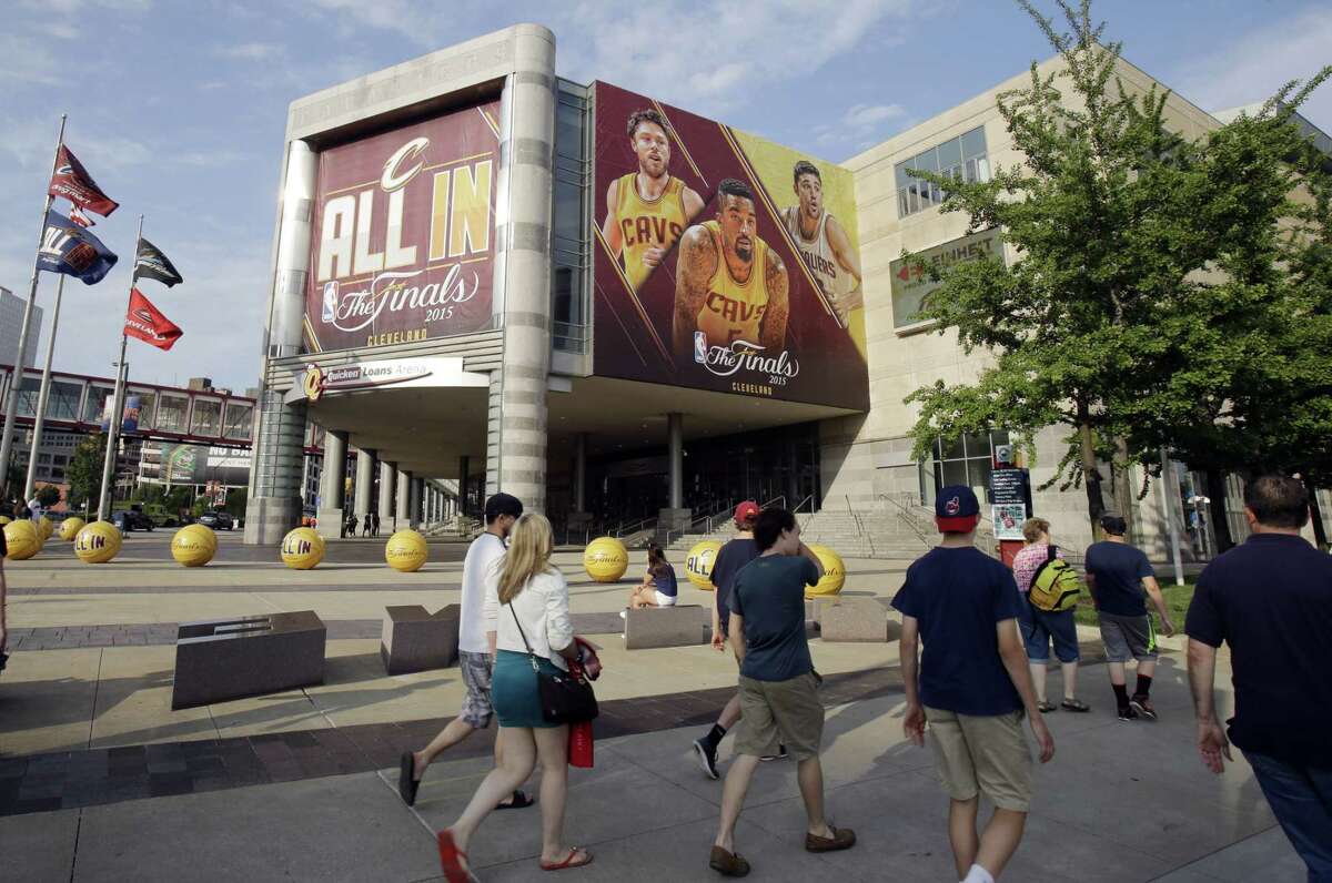 Pedestrians pass Quicken Loans Arena in Cleveland.