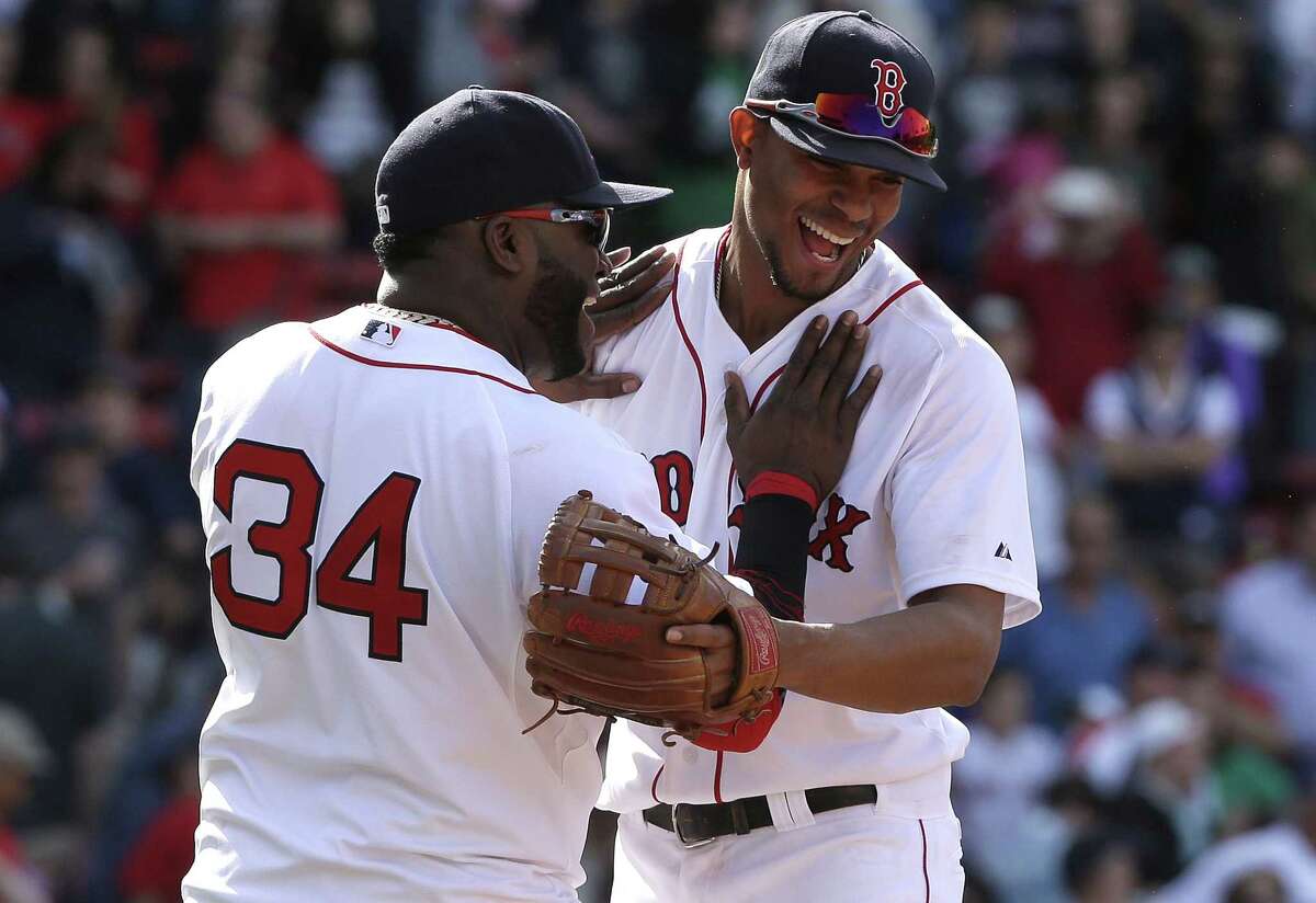 Boston’s David Ortiz, left, celebrates with teammate Xander Bogaerts after they defeated the Athletics on Sunday.