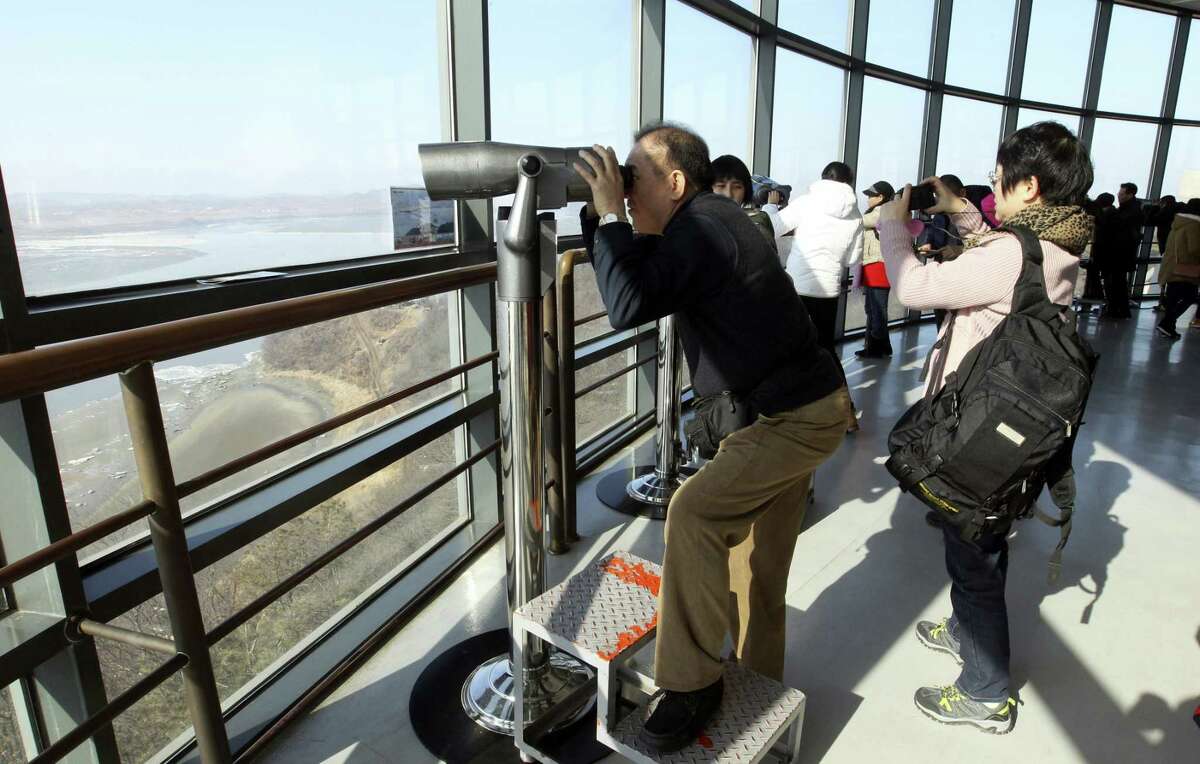 Visitors watch the North Korean side at the unification observation post near the border village of Panmunjom, which has separated the two Koreas since the Korean War, in Paju, South Korea on Feb. 7, 2016. For North Korea’s propaganda machine, the long-range rocket launch Sunday carved a glorious trail of “fascinating vapor” through the clear blue sky. For South Korea’s president, and other world leaders, it was a banned test of dangerous ballistic missile technology and yet another “intolerable provocation.”