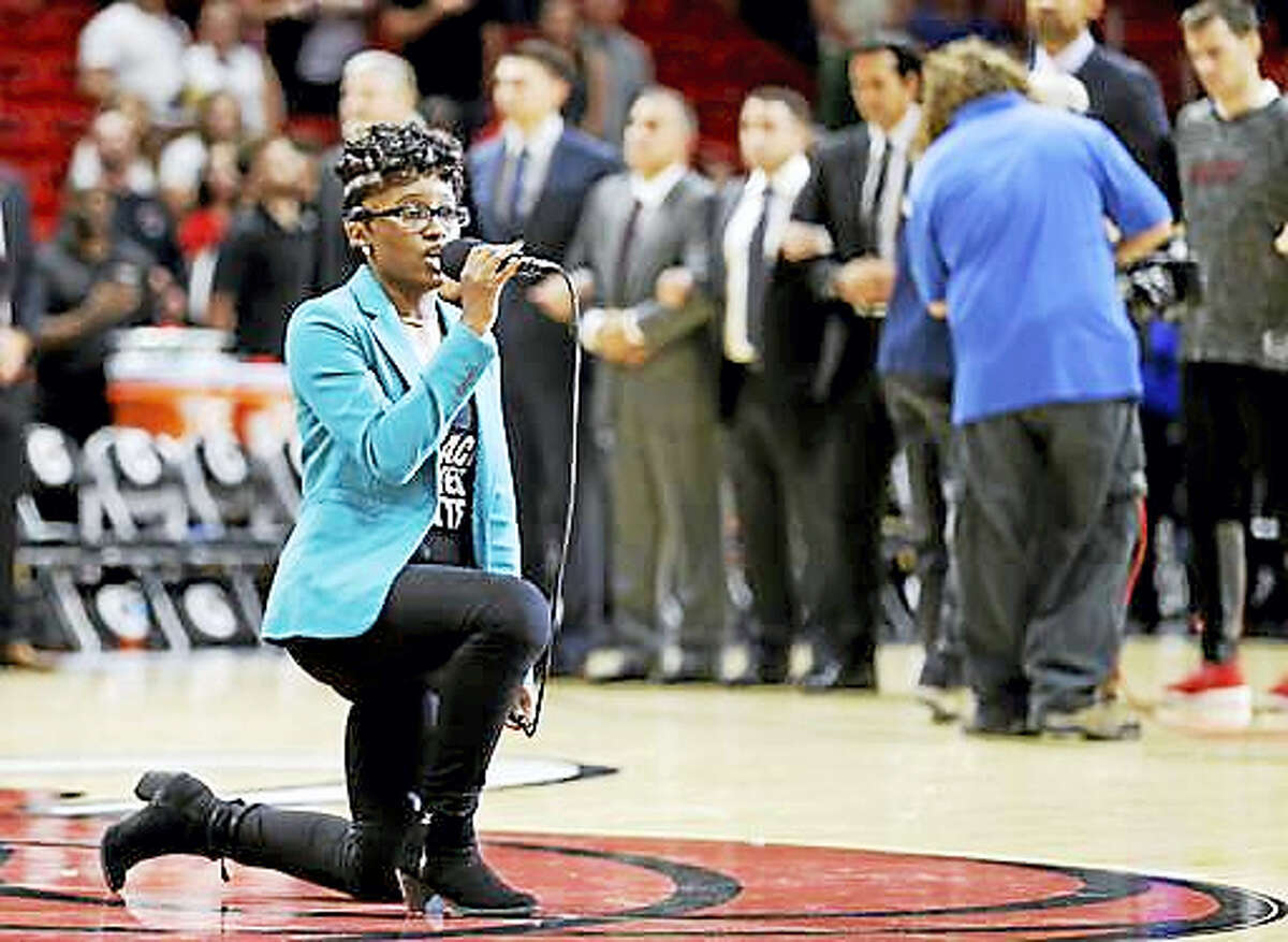 Denasia Lawrence sings the national anthem before an NBA preseason basketball game between the Miami Heat and the Philadelphia 76ers, Friday, Oct. 21, 2016, in Miami.