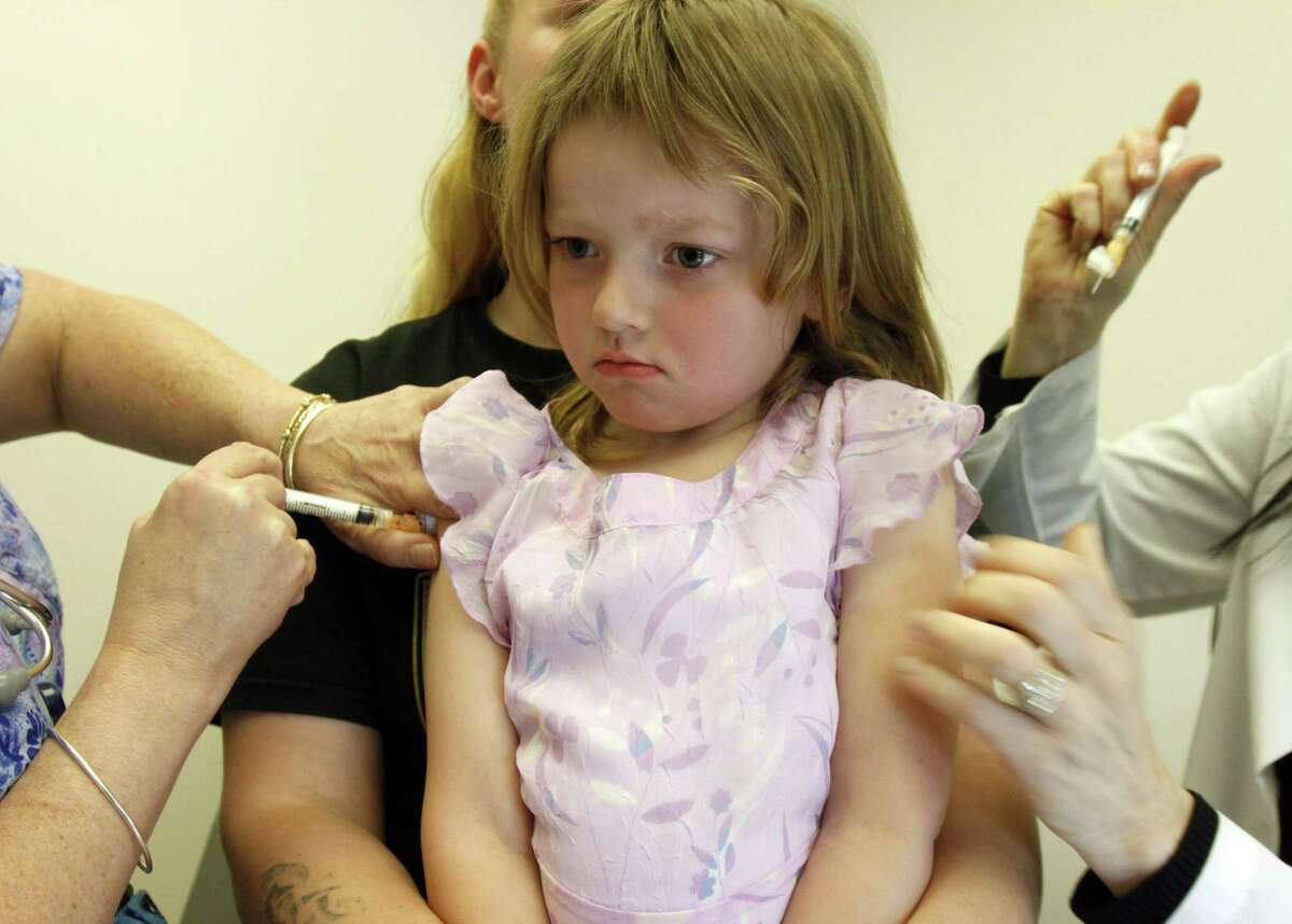 In this April 20, 2012, photo, Holly Ann Haley gets vaccinations at the doctor’s office in Berlin, Vt.