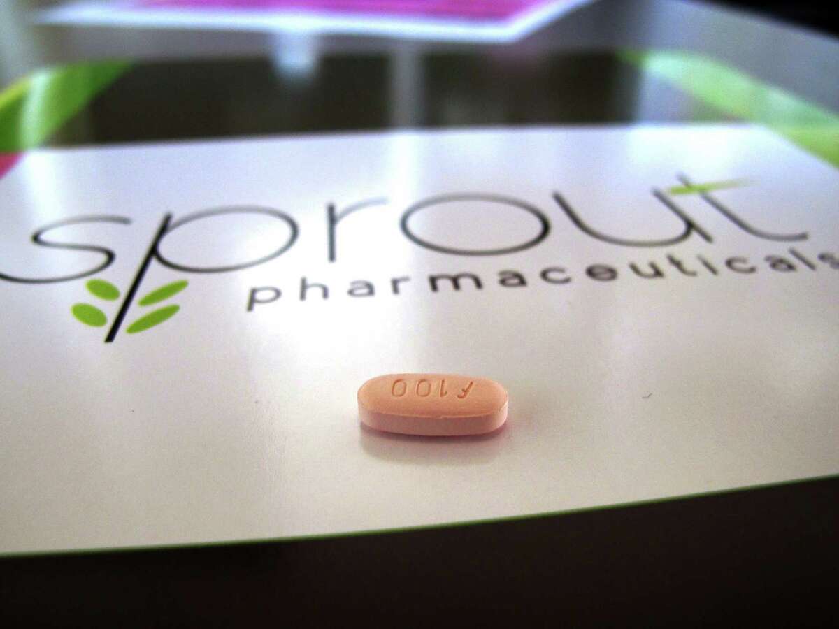A tablet of flibanserin sits on a brochure for Sprout Pharmaceuticals in the company’s Raleigh, N.C., headquarters. Government health experts on Thursday, June 4, 2015 backed the approval of the experimental drug intended to boost the female sex drive, but stress that it should carry safety restrictions to manage side effects including fatigue, low blood pressure and fainting.