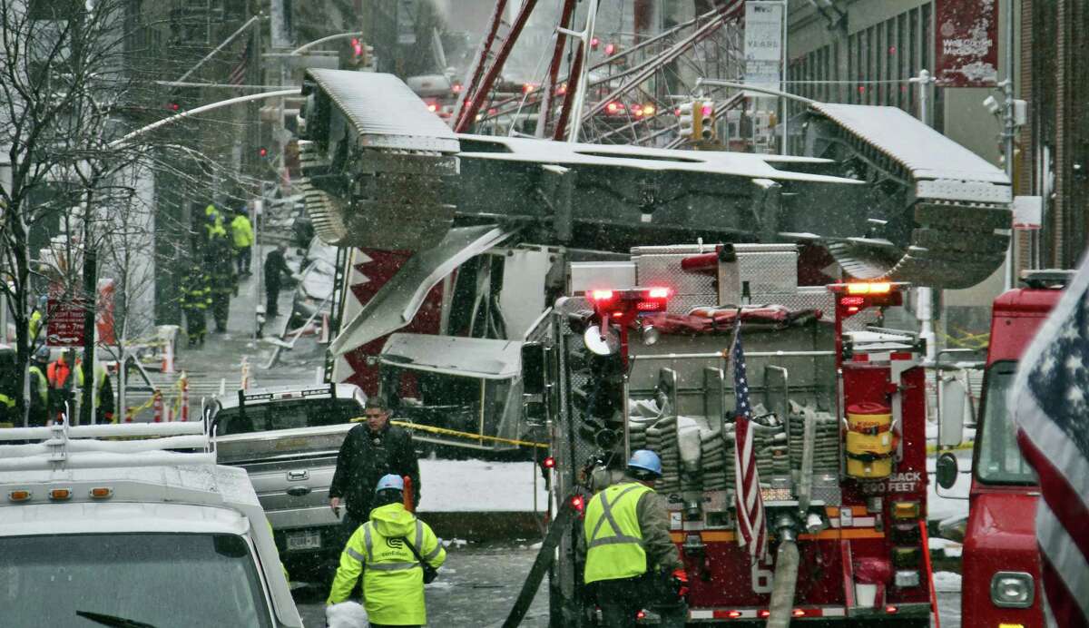 A collapsed crane lies on the street on Feb. 5, 2016 in New York. The crane landed across an intersection and stretched much of a block in the Tribeca neighborhood, about 10 blocks north of the World Trade Center.