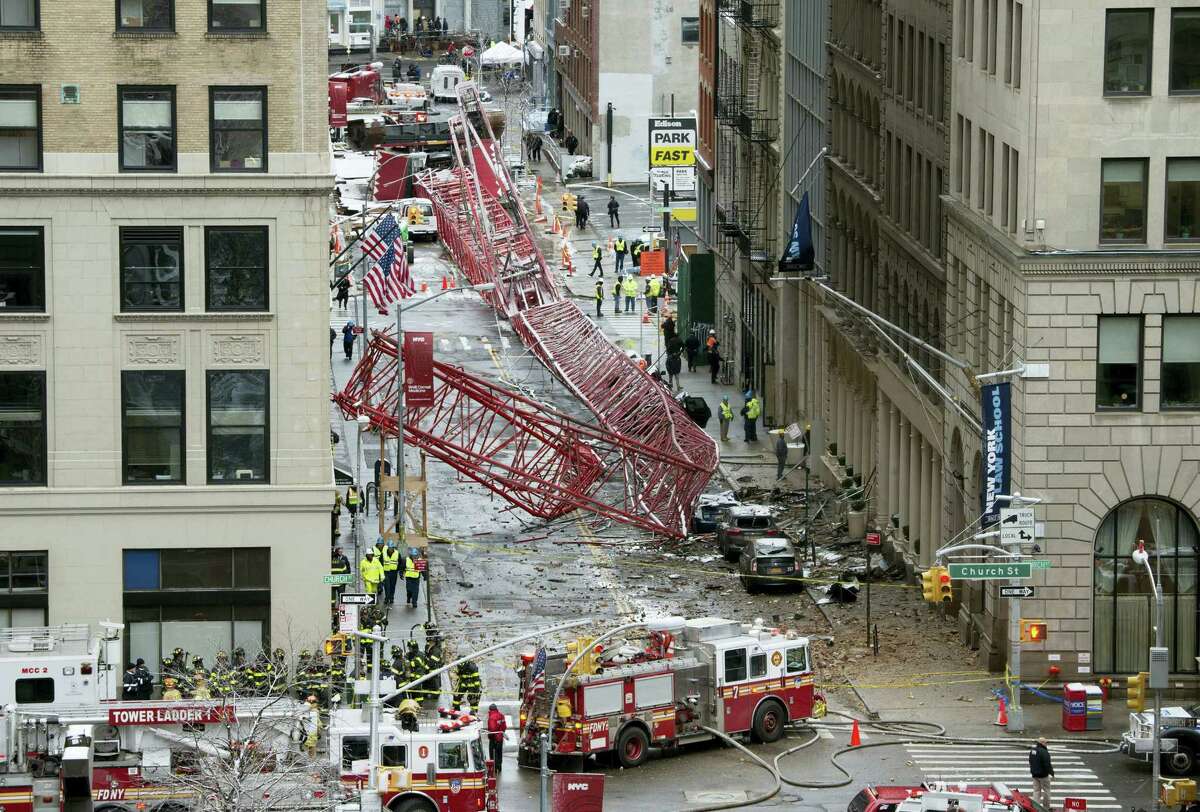 A collapsed crane fills the street on Feb. 5, 2016 in New York. The huge construction crane was being lowered to safety in a snow squall when plummeted onto the street in the Tribeca neighborhood of lower Manhattan.