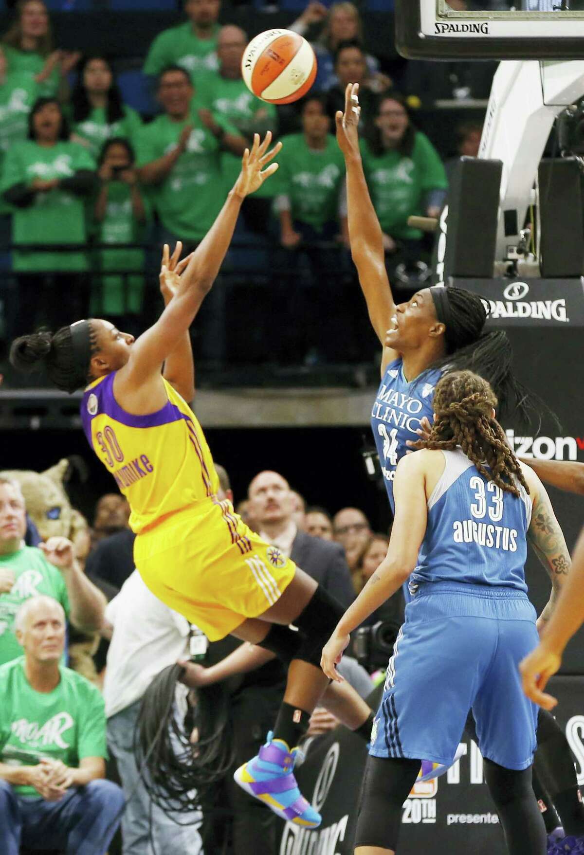 Los Angeles Sparks’ Nneka Ogwumike, left, shoots the game wining shot with about 4 seconds left over Minnesota Lynx defender Sylvia Fowles on Thursday.