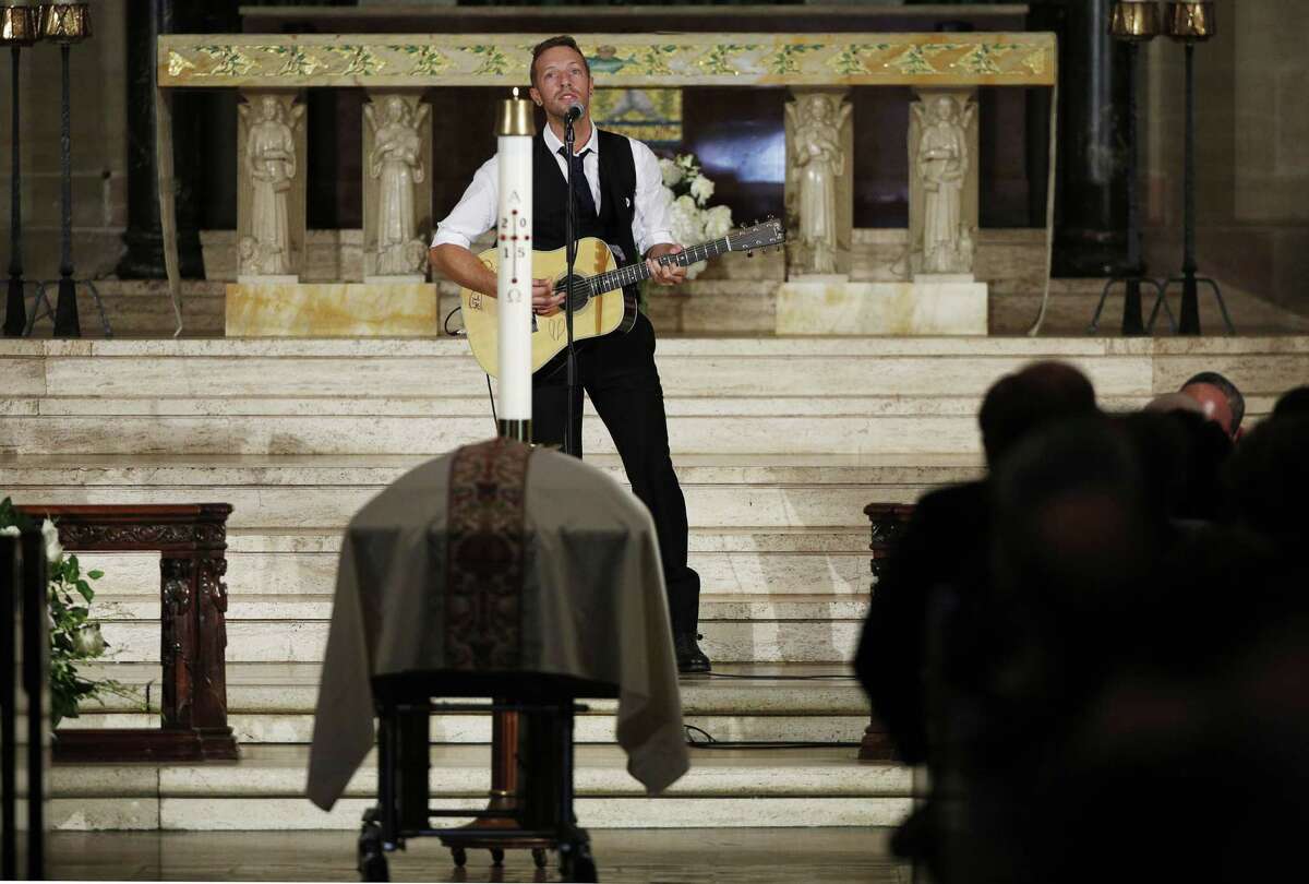 Chris Martin on the group Coldplay performs "Til Kingdom Comes" during funeral services for Vice President Joe Biden's son, former Delaware Attorney General Beau Biden, Saturday, June 6, 2015, at St. Anthony of Padua Church in Wilmington, Del. Vice President Joe Biden's eldest son, died at the age of 46 after a battle with brain cancer. (Kevin Lamarque/Pool Photo via AP)