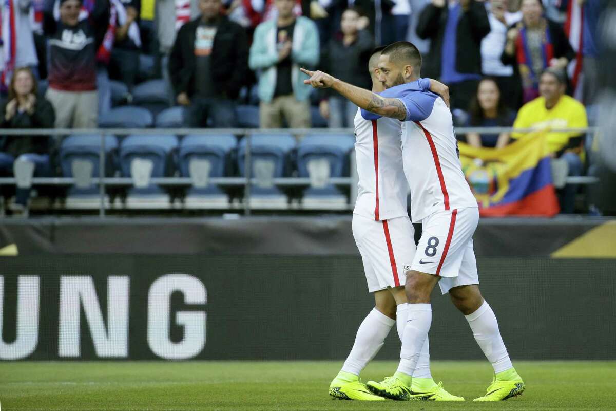 Clint Dempsey, right, celebrates with a teammate after scoring his side’s first goal against Ecuador on Thursday.