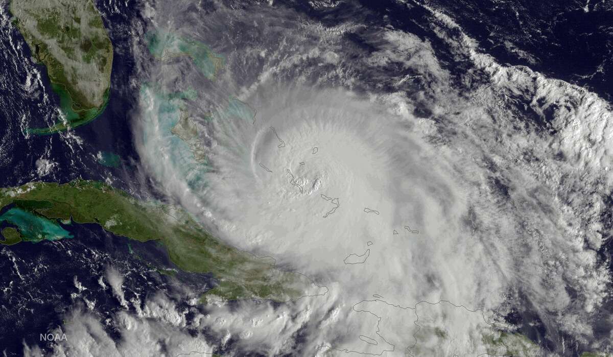 This satellite image taken Friday, Oct. 2, 2015 at 8:45 a.m. EDT, and released by the National Oceanic and Atmospheric Administration (NOAA), shows Hurricane Joaquin of the Bahamas. The Category 4 storm ripped off roofs, uprooted trees and unleashed heavy flooding as it hurled torrents of rain across the eastern and central Bahamas on Friday, and the U.S. Coast Guard said it was searching for a cargo ship with 33 people aboard that went missing during the storm.