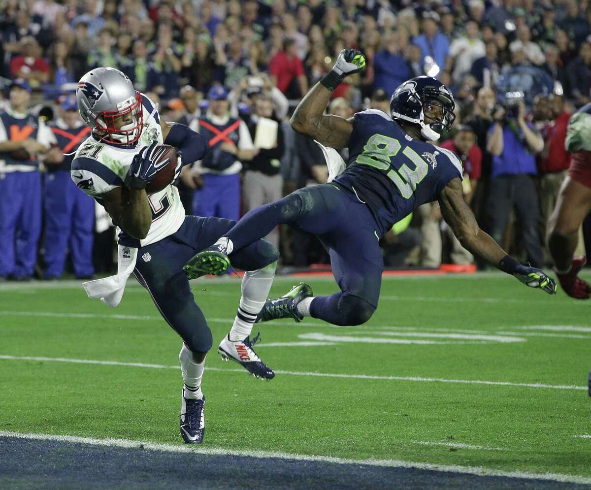 New England Patriots strong safety Malcolm Butler (21) intercepts a pass intended for Seattle Seahawks receiver Ricardo Lockette (83) during the closing minute of Sunday’s Super Bowl in Glendale, Ariz.