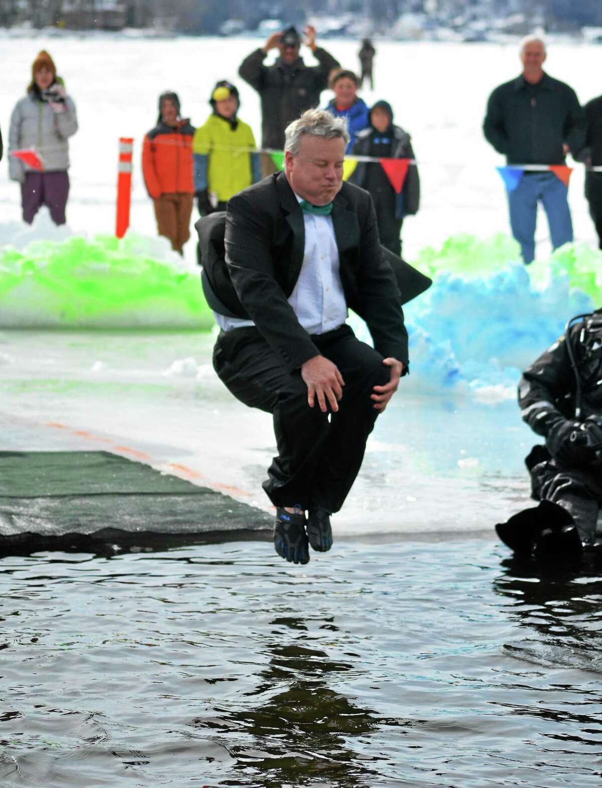Winsted Town Manager Dale Martin dives in to Highland Lake as part of the Penguin Plunge, a fundraiser held annually in Winsted for Special Olympics.