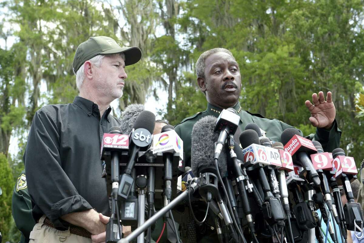 Nick Wiley, executive director of the Florida Fish & Wildlife Conservation Commission, left, and Orange County Sheriff Jerry Demings answer questions from reporters during a news conference Wednesday, June 15, 2016, in Lake Buena Vista, Fla., after a toddler was dragged into the lake Tuesday eveningby an alligator outside Disney’s Grand Floridian Resort & Spa.
