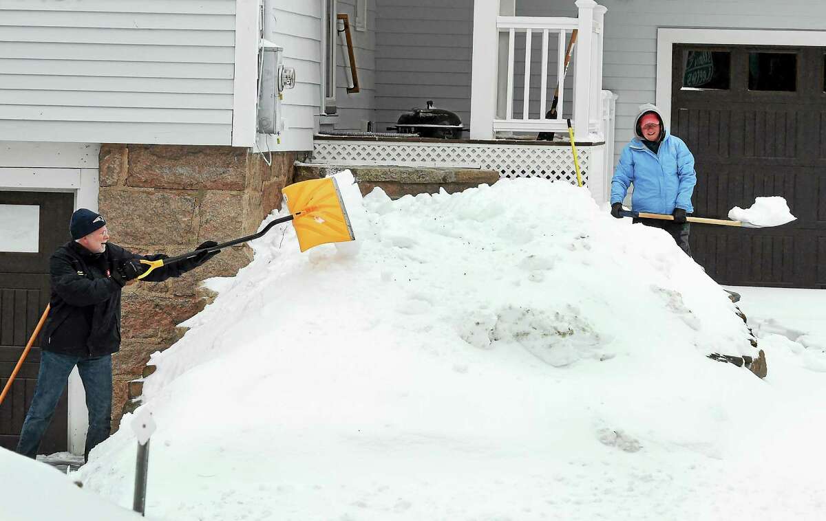 Bob and Maureen Lamb clear their two driveways of snow at their Thimble Island Road home in Branford, Conn. Monday, February 2, 2015.