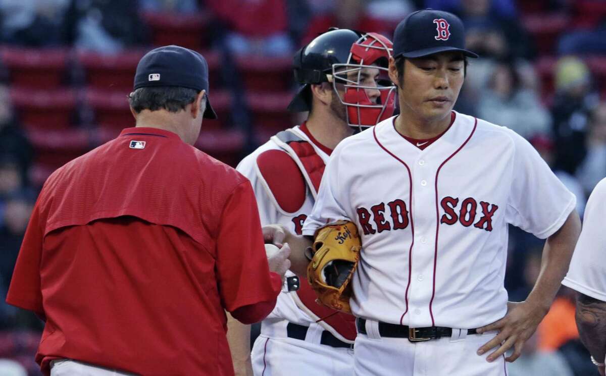 Red Sox closer Koji Uehara hands the baseball to manager John Farrell as he is taken out in the ninth inning on Thursday.