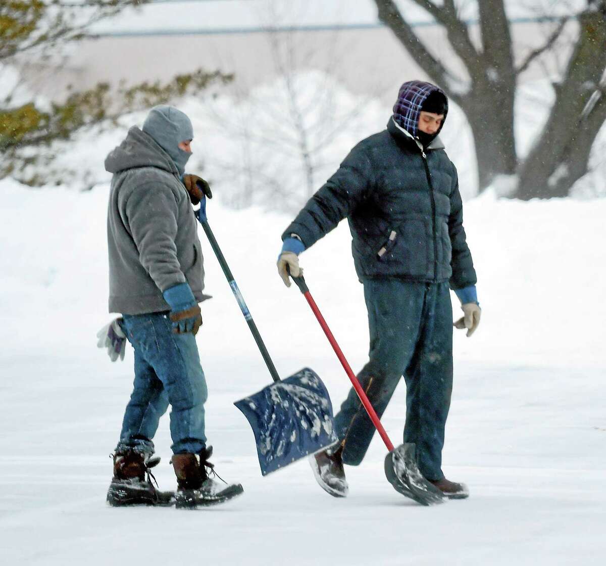 Shovelers walk across the parking lot of the Connecticut Post Mall in Milford Monday morning 2/2/2015.