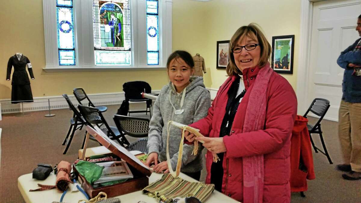 Wava Chan of Brookfield and Leslie Huston of Newtown learn about tape loom weaving during a class at the Litchfield Historical Society on Saturday.