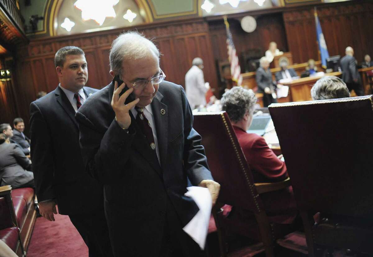 Connecticut State Senate President Martin Looney takes a phone call in Senate Chambers at the Capitol on the final day of session Wednesday in Hartford.