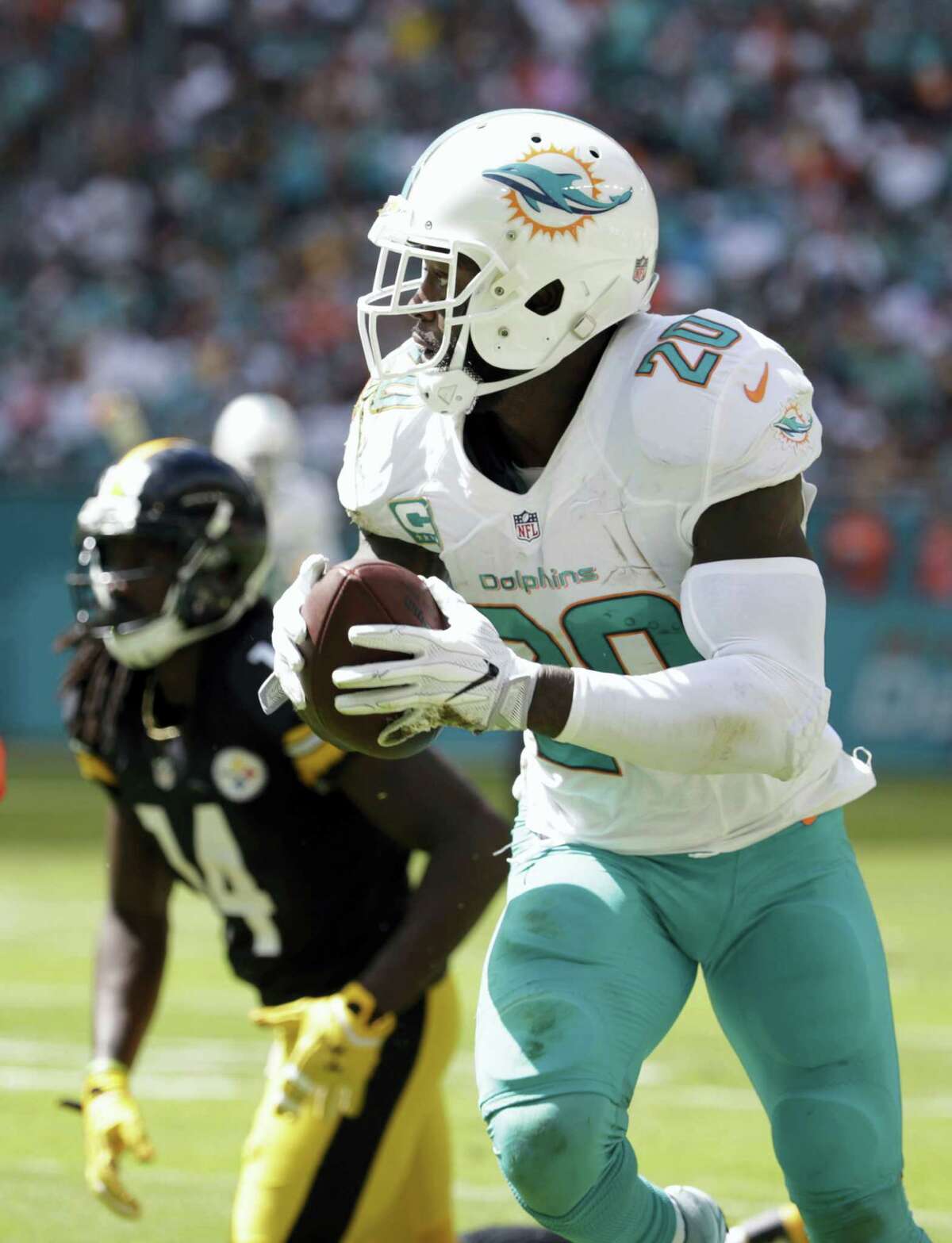 Miami Dolphins free safety Reshad Jones (20) intercepts a ball intended for Pittsburgh Steelers wide receiver Sammie Coates (14), during the first half of an NFL football game on Oct. 16, 2016 in Miami Gardens, Fla.