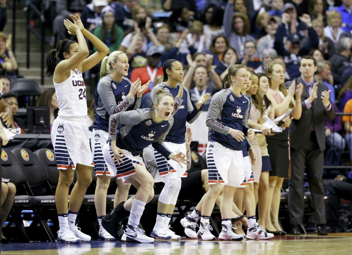 Connecticut's Katie Lou Samuelson, second from left, joins the bench to cheer during the second half of a national semifinal game against Oregon State, at the women's Final Four in the NCAA college basketball tournament Sunday, April 3, 2016, in Indianapolis. (AP Photo/Michael Conroy)