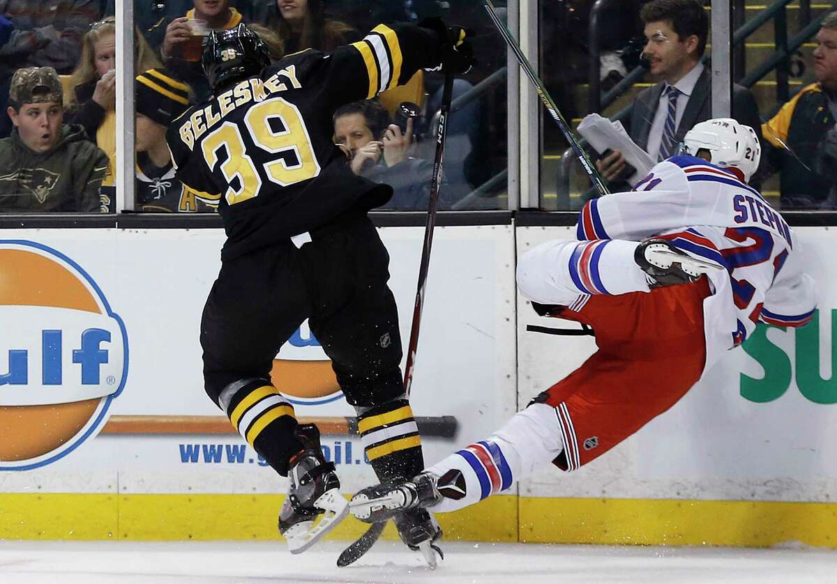 The Bruins’ Matt Beleskey checks the Rangers’ Derek Stepan during Friday’s game in Boston. Stepan suffered broken ribs on the play and will be out 4-6 weeks.