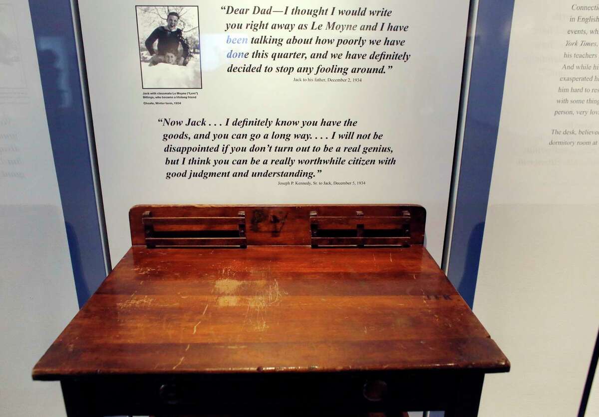 In this Nov. 5, 2015 photo, a desk is displayed in the exhibit titled “Young Jack” at the John F. Kennedy Presidential Library and Museum in Boston. An archivist at Choate, the private school in Connecticut where the president studied as a boy, insists the desk didn’t belong to him.